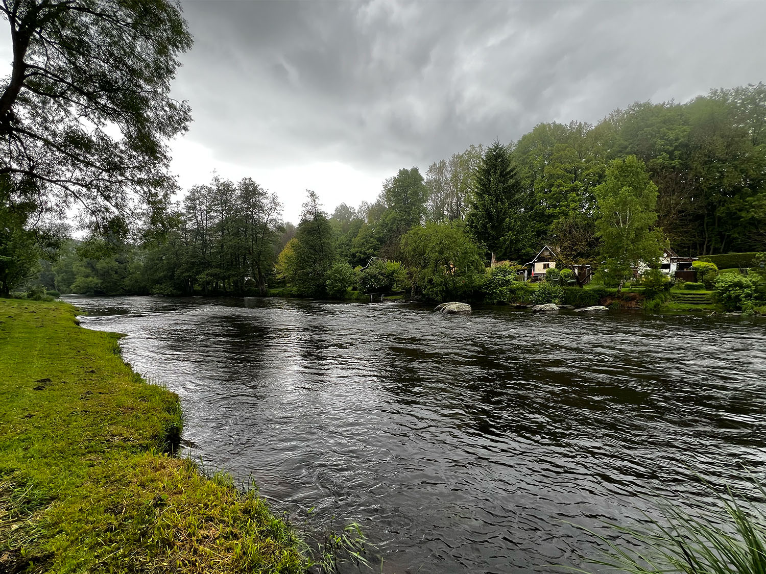The fast shallow riffle below the main run with eddies on the far bank behind the rocks